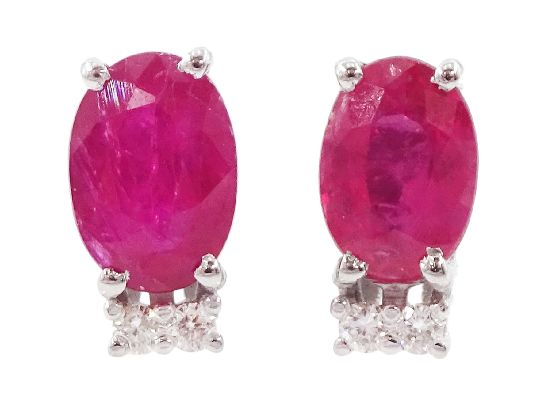 Pair of 18ct white gold oval cut ruby and two stone round brilliant cut diamond stud earrings, total ruby weight approx 1.10 carat