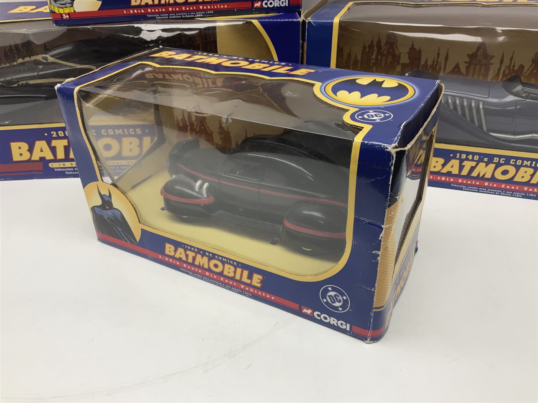 Five Corgi Batmobile die-cast vehicles from the DC Comics collection, to include 1940’s DC Comics BMBV2 1:18 and BMBV1 1:24 scale Batmobiles, all in original boxes 