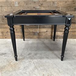 Ebonised square games table, reversible chessboard top revealing games compartment