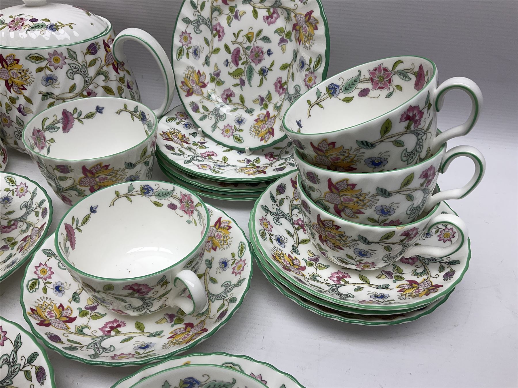 Minton Haddon Hall pattern tea service for twelve place settings, to include teapot, sugar bowl, milk jug, twelve cups and saucers and twelve dessert plates (39)