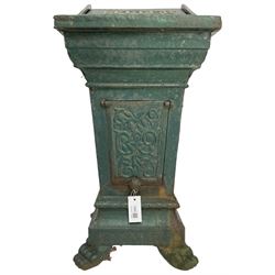 Early 20th century cast iron litter bin, square tapering form with scrolling foliate decoration, on paw feet