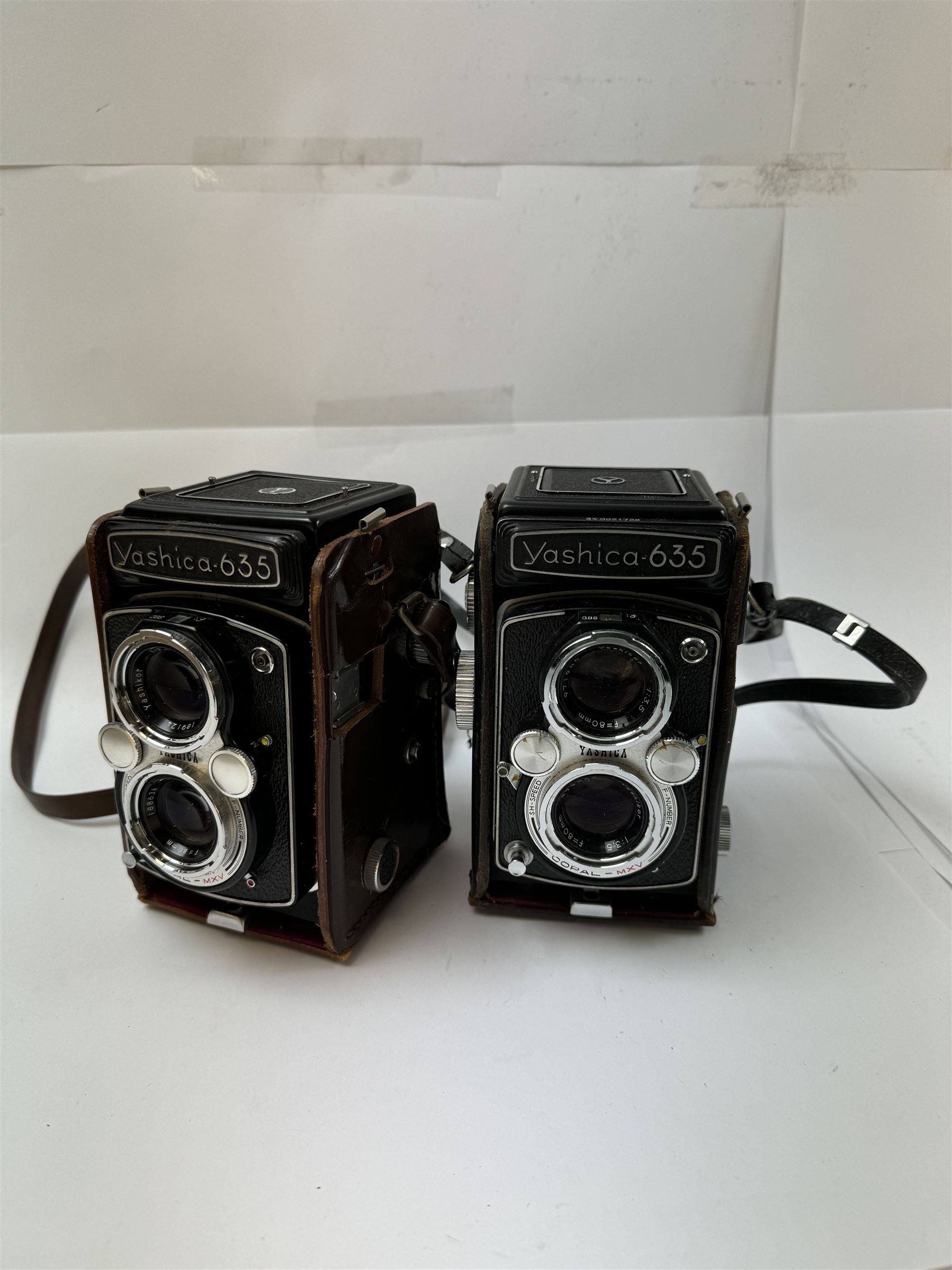 Two Yashica-635 Copal-MXV medium format TLR film cameras, circa 1970s, serial nos. ST 4041084 & SX 0031728, each with twin Yashikor 1:3.5 f-80mm lenses, in leather carry cases