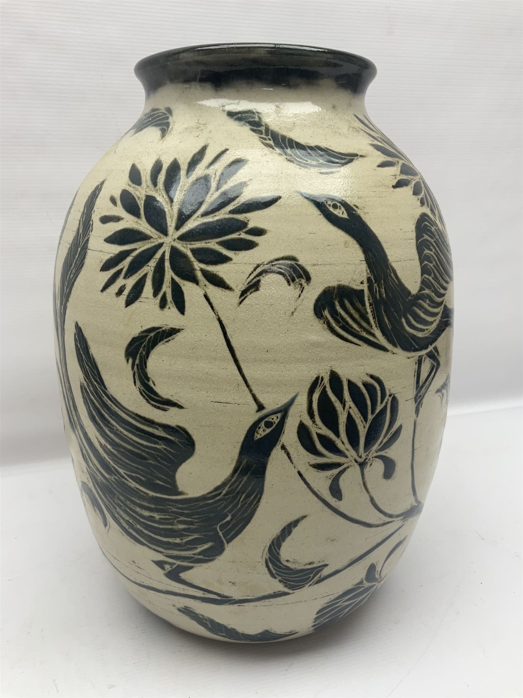 John Egerton (c1945-): studio pottery stoneware vase decorated with birds in flowers braches upon a white ground, H40cm