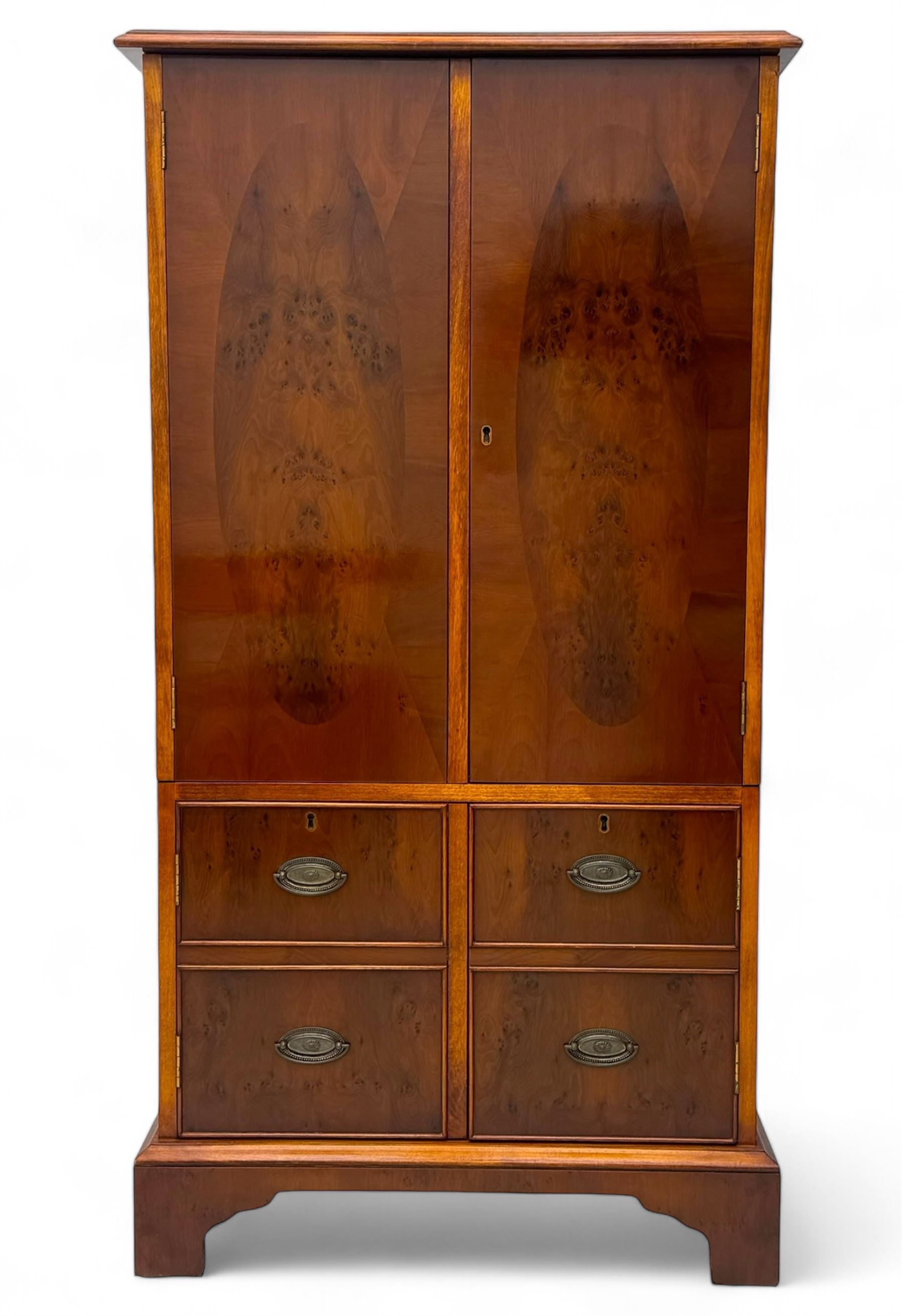 Wade - yew wood hi-fi cabinet, moulded rectangular hinged top over double-door cupboard with figured veneer, enclosing three adjustable shelves, lower section fitted with two cupboards to resemble four drawers, enclosing three drawers and open storage