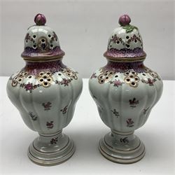 Pair of pot pourri vases and covers, decorated with floral sprigs and with rose finials to the covers, H24cm