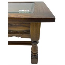 Old Charm - oak coffee table, rectangular top with glass inset over carved scalloped apron, on turned square supports connected by H-stretcher