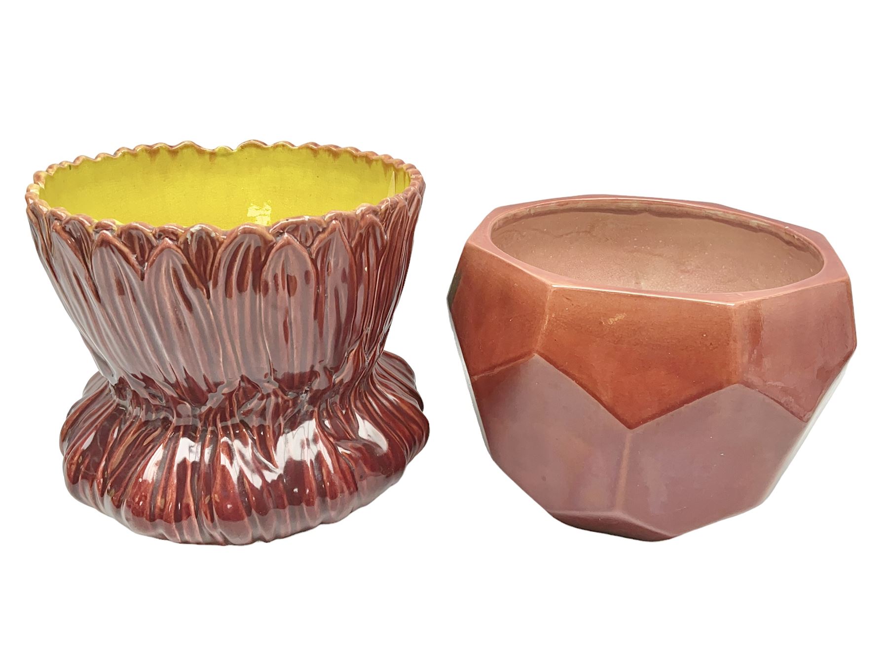 Two Bretby jardinieres, the first example with geometric hexagonal decoration in a red glaze, the second moulded as a flower head, in red glaze with yellow glaze to interior,  both with impressed marks beneath, tallest H25.5cm