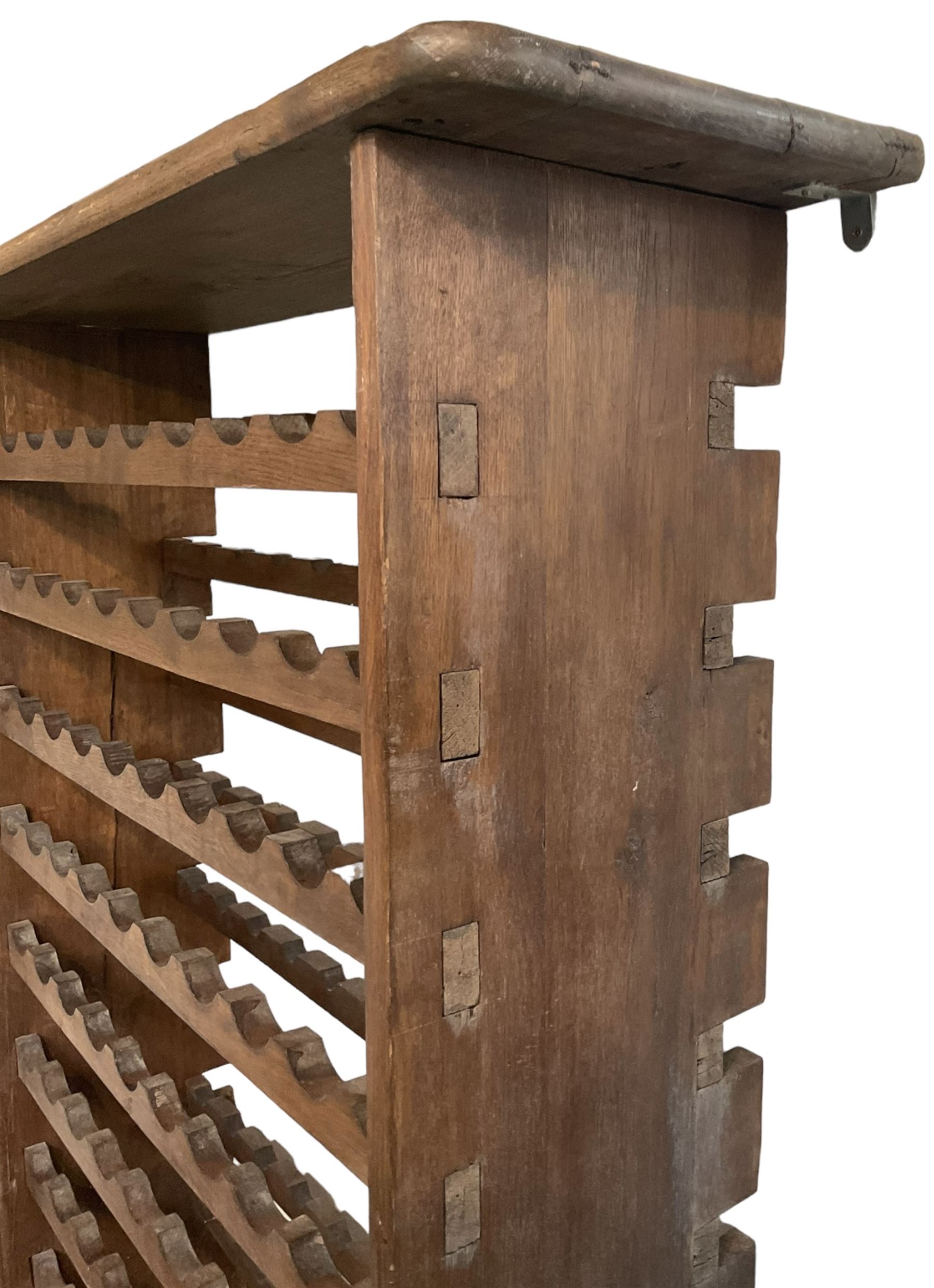 Large reclaimed oak eight tier wine rack, rectangular top over eight racks each with ten bottle divisions, on end supports