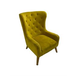 Mid-20th century design armchair, barrel back upholstered in buttoned mustard fabric, on tapering splayed front feet