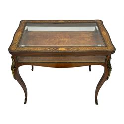 Victorian inlaid rosewood bijouterie table cabinet, shaped form, enclosed by hinged bevel glazed lid with shell and floral inlays, fabric lined interior, glazed sides within foliate cast gilt metal edging, on cabriole supports with floral cast gilt metal mounts and terminal caps 