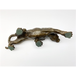 A bronze figure, modelled as a cougar in crouching pose, signed Milo and with foundry mark, L40cm. 