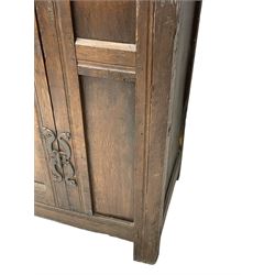 17th century and later oak hall cupboard, panelled front and sides with moulded frame, enclosed by single door with wrought metal hinges and handle, the interior fitted with hooks, on stile supports 