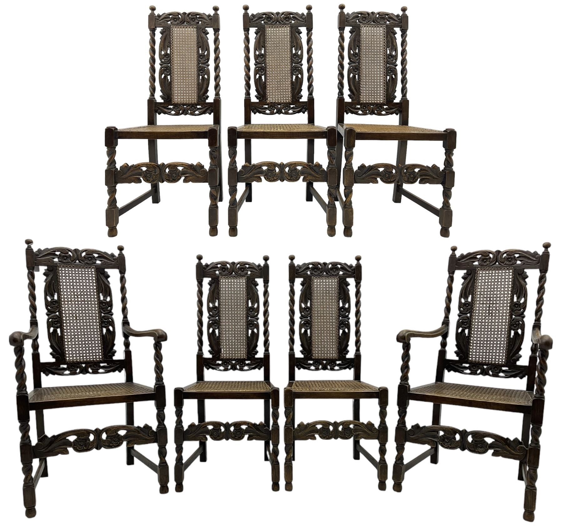 Set of seven (5+2) 19th century Carolean design oak dining chairs, scroll leaf and flower head carved cresting rail over spiral turned uprights and cane work back, the cane work seat on spiral turned supports united by plain stretchers, scrolled leaf carved middle rail 