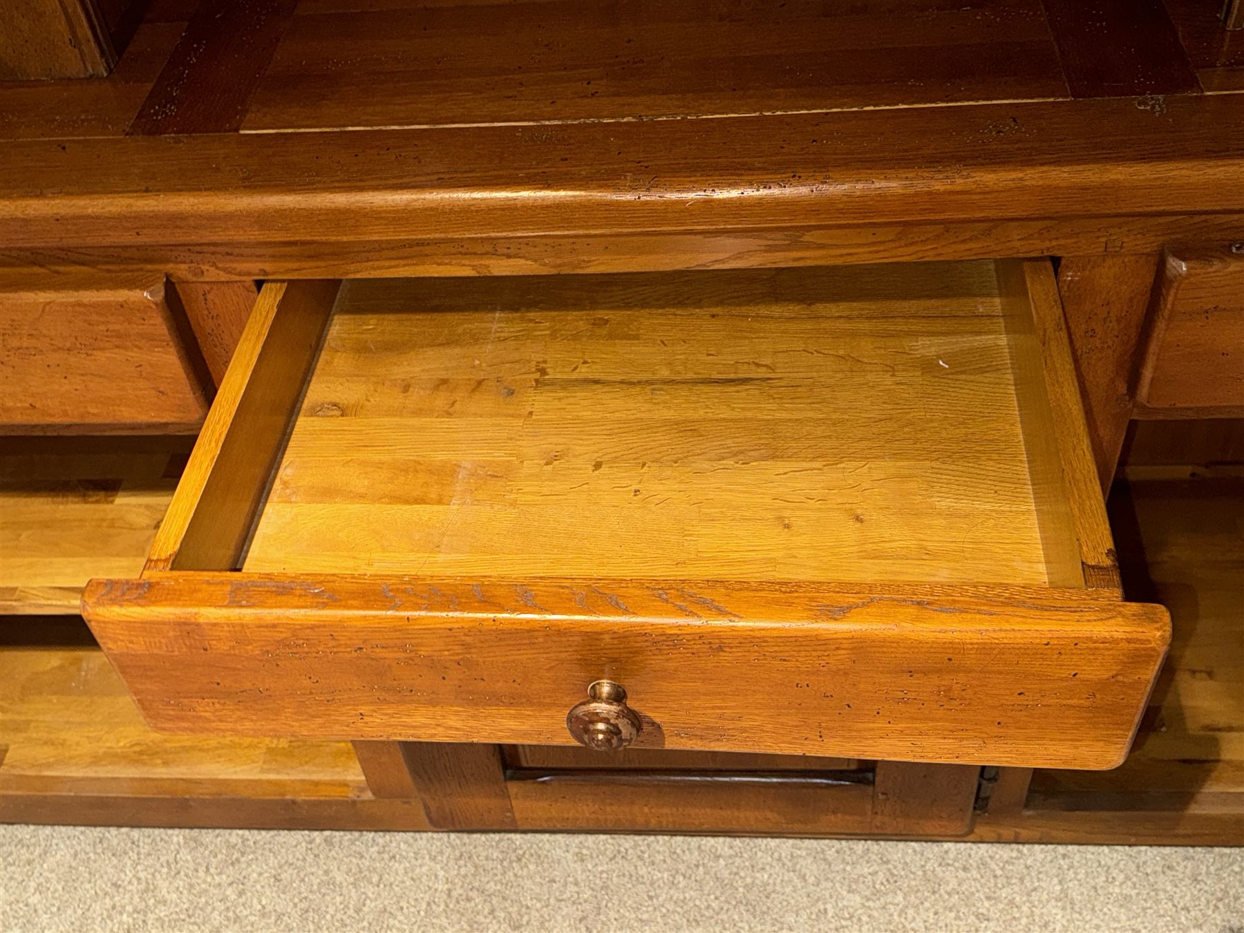 Large 20th century oak dresser, projecting cornice over open arched central section with two shelves, flanked by two panelled cupboards with two shelves, lower section with three drawers above three cupboards, on stile supports 