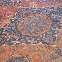 Old Persian red ground flat woven carpet, the field with three large medallions surrounded by small stylised flower head motifs, geometric border enclosed within running water band 346