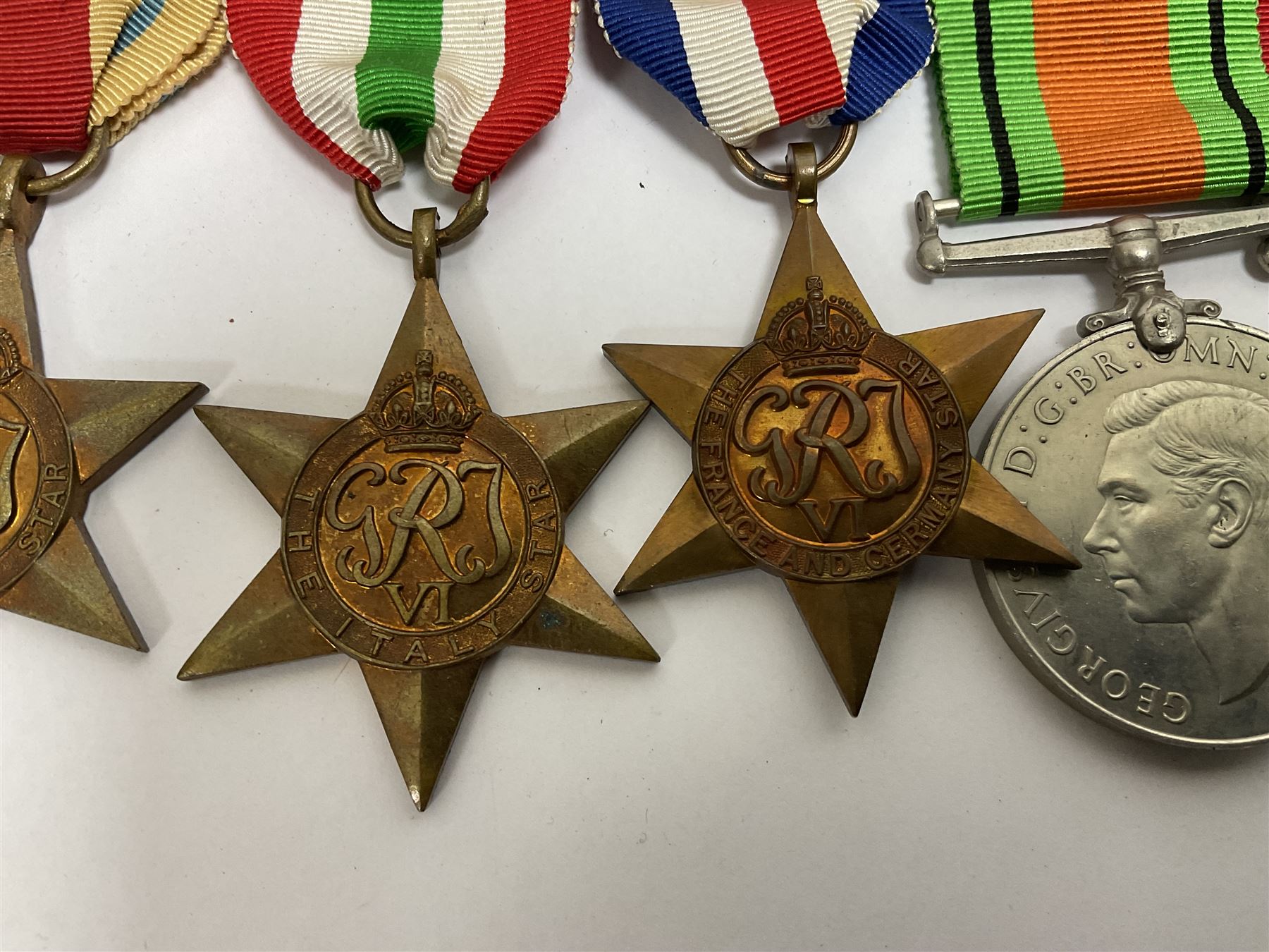 WWII group of six medals comprising 1939-45 Star, The Africa Star, The Italy Star, France and Germany Star, Defence Medal and War Medal 1939-45, awarded to 7899181 RAC C.W Hughes, together with two chevrons and ephemera relating to Charles William 'Bill' Hughes including Soldier's Release Book, photographs, certificates of transfers etc 