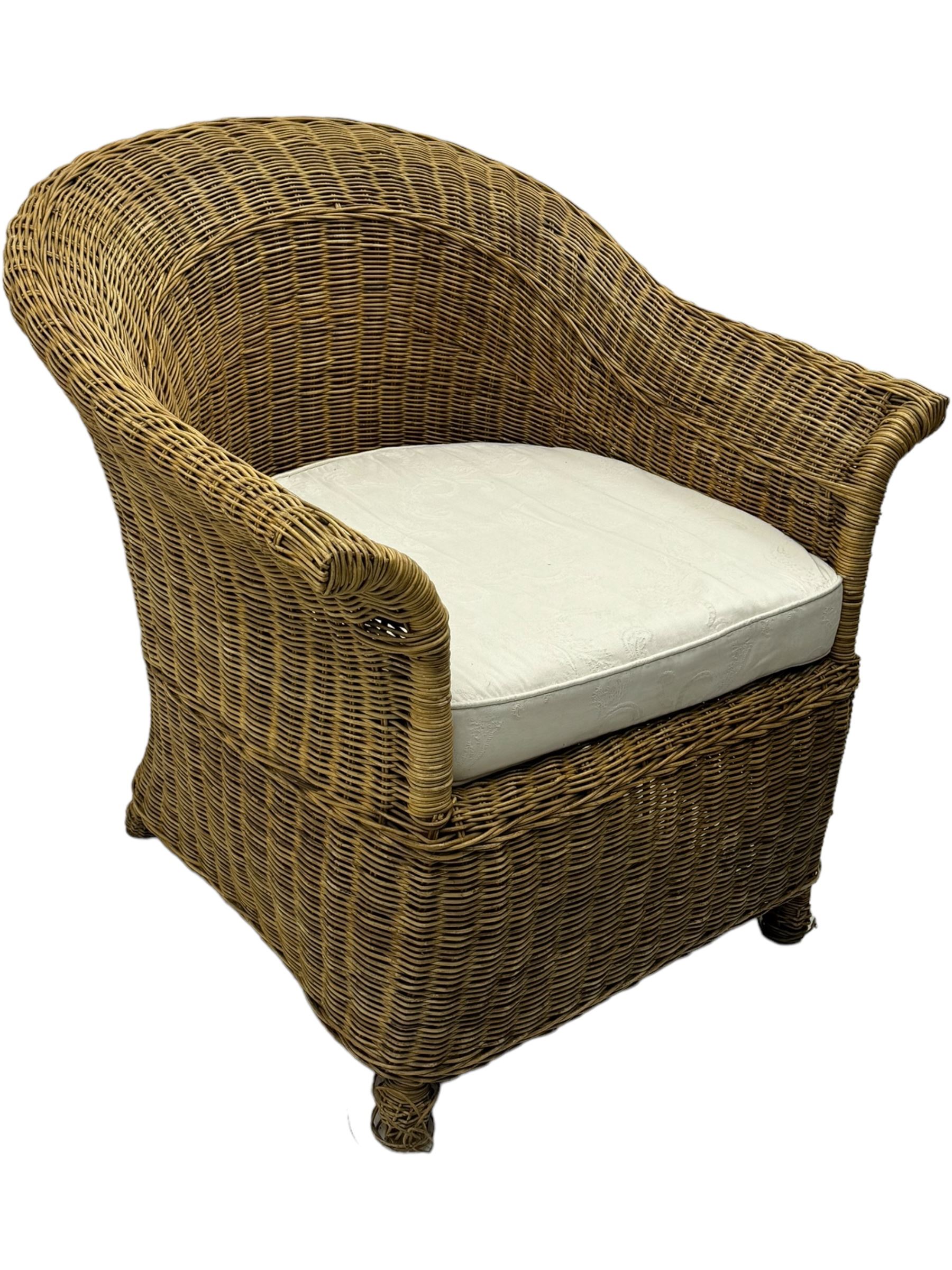 Rattan armchair and ottoman set, pair of armchairs featuring rounded backrests with wide armrests, woven wicker frame with weaving and upholstered seat cushions in off-white fabric with flowing floral pattern (W83 D80 H78cm); matching round ottoman with upholstered cushion on square wooden feet (W65 D65 H37cm)