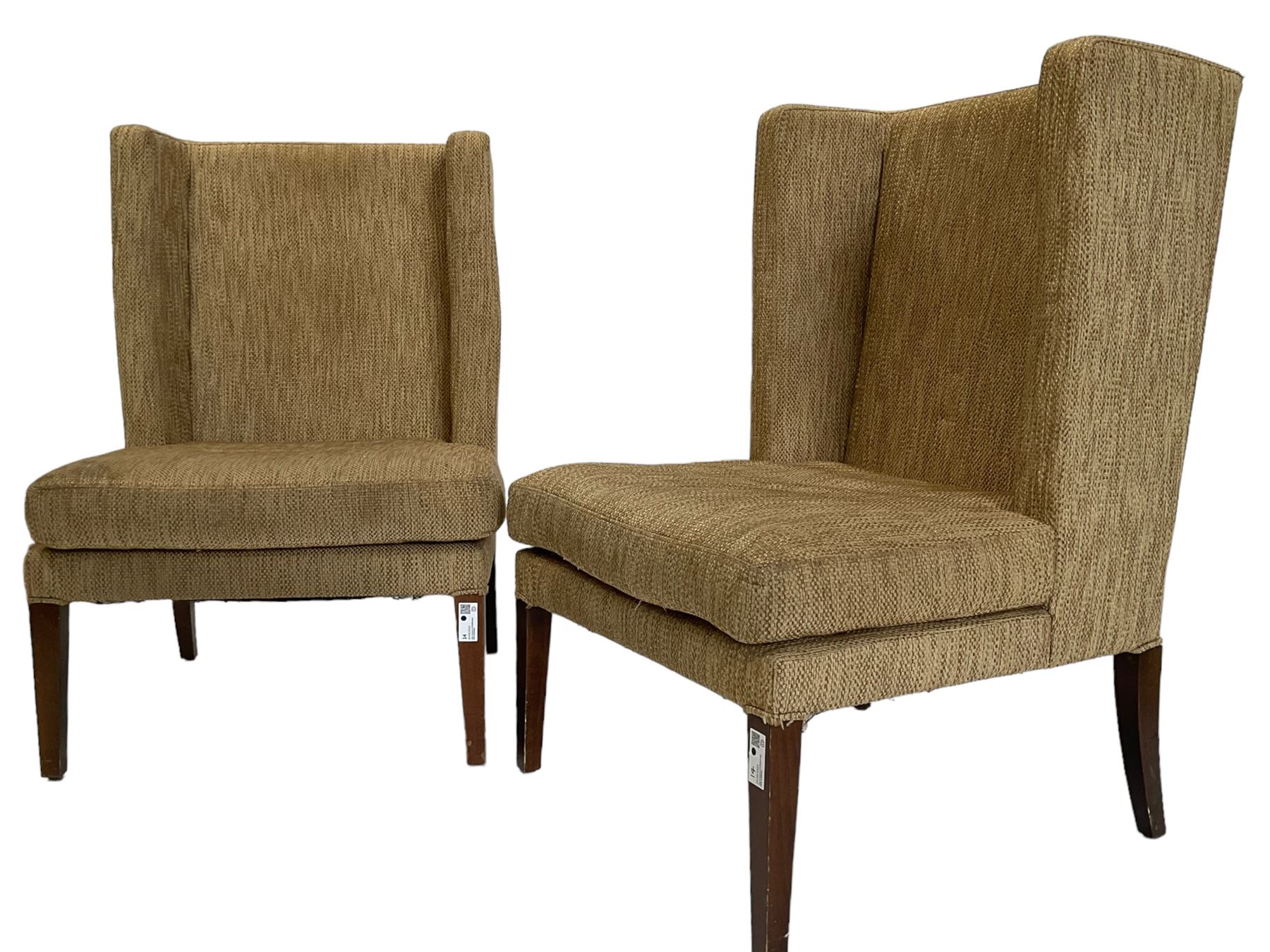 Two wing back armchairs, upholstered in oatmeal fabric