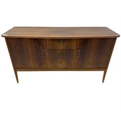 Mid 20th century teak sideboard, rectangular top with rounded corners over three central drawers, flanked by two cupboard doors enclosing shelves, raised on tapered supports