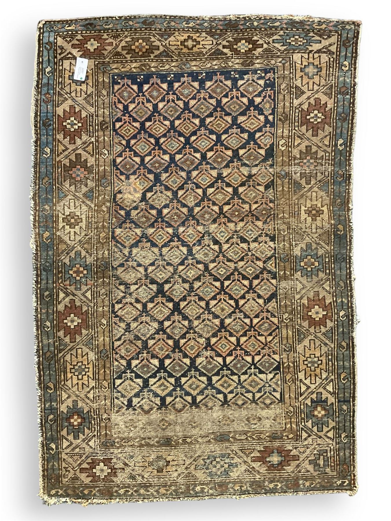 Caucasian indigo ground rug, the field decorated with geometric motifs within geometric pattern borders 