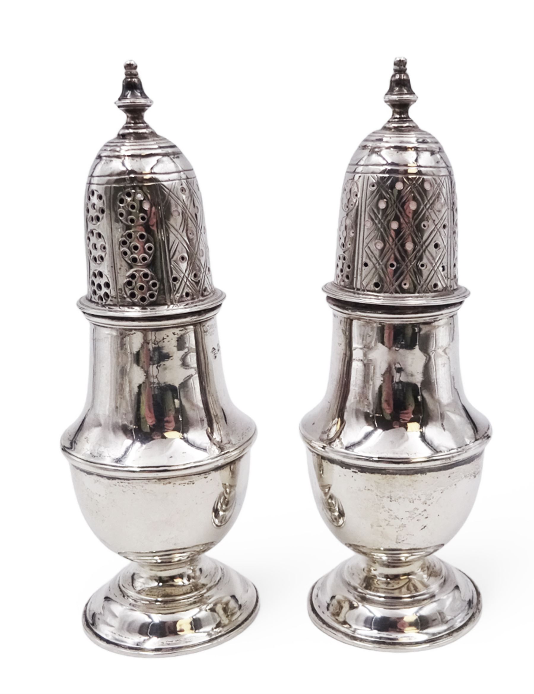 Pair of Victorian silver sugar casters, of typical waisted form, the removable pierced cover with urn finial, upon domed circular foot, hallmarked Sheffield 1880, maker's mark WB, H14.5cm