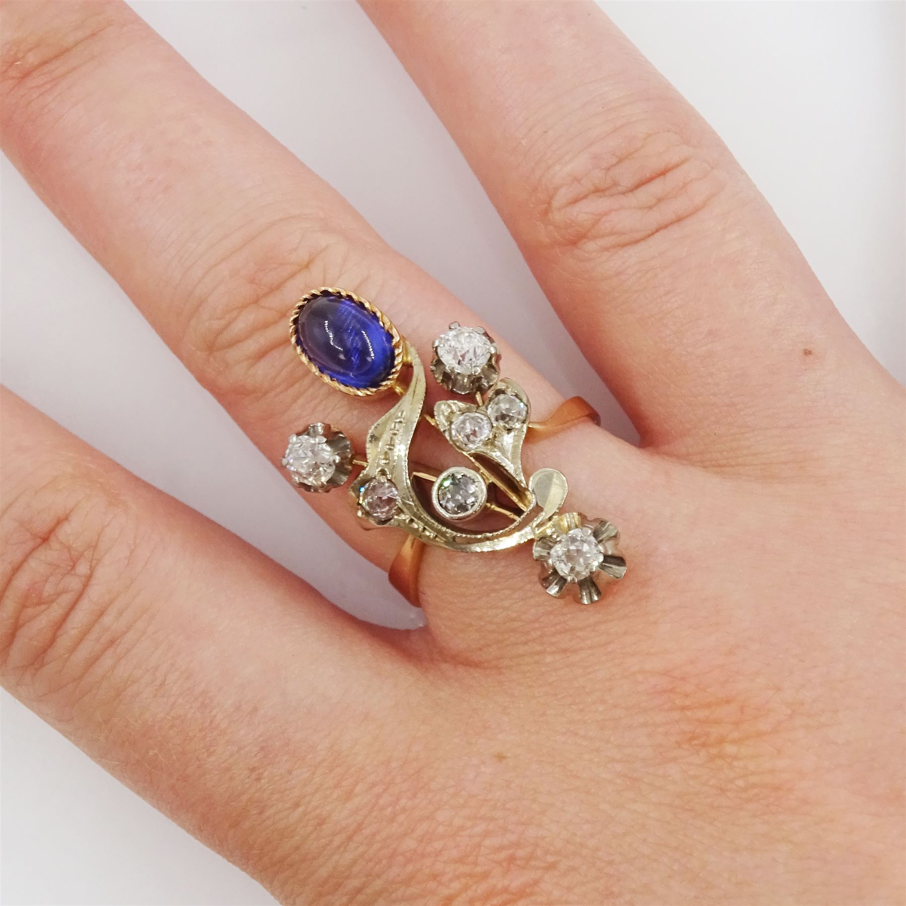 Russian early 20th century 14ct rose and white gold, oval cabochon cut synthetic sapphire and old cut diamond flower design ring, stamped 585 with Soviet star, total diamond weight approx 0.60 carat