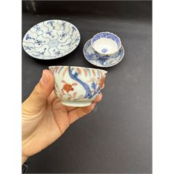 Early 19th century Chinese Tek Sing bowl, decorated with stylised blossoms, with 'Nagel Auctions' label to base, H6.5cm D15.5cm, together with a  Tek Sing similar saucer, D18cm, a Chinese tea bowl decorated in blue and red blossoming flowers, a Chinese blue and white saucer, and an English blue and white Willow pattern tea bowl, (5)