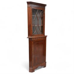 Georgian design mahogany floor standing corner cabinet, projecting moulded cornice over bl...