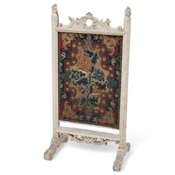 19th century carved wood fire screen, with lift-up tapestry panel, pierced pediment carved with C-scrolls and curled leaves, flanked by moulded uprights with torch finials, on scrolled out splayed feet 