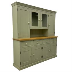 Painted kitchen dresser, projecting moulded cornice over central glazed display doors and flanking panelled cupboard doors, polished oak rectangular top over four drawers and four cupboards, on moulded plinth base, in laurel green paint finish 