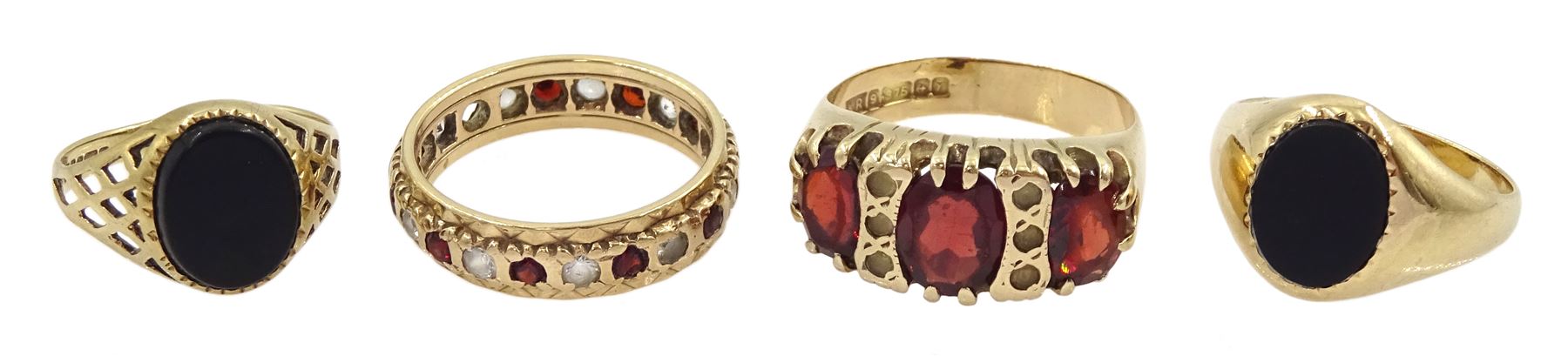 Four 9ct gold stone set rings including two black onyx signet rings, garnet and paste stone and a full eternity ring, all hallmarked