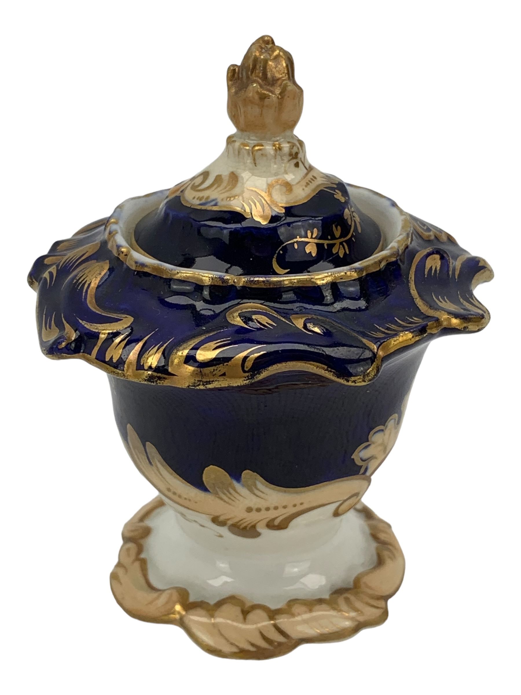 19th century porcelain inkstand, the oblong twin handled base centrally painted with a floral bouquet, flanked by two footed inkwells and covers, with rococo-inspired acanthus moulded borders and handles, pattern no. 2/3339, L26.5cm 