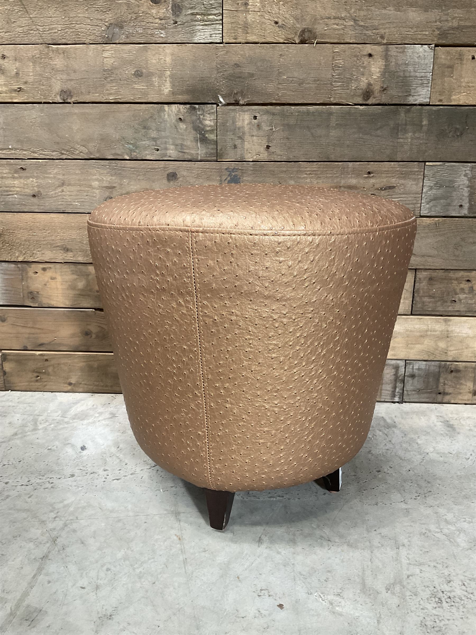 Four circular tapered stools, upholstered in gold fabric