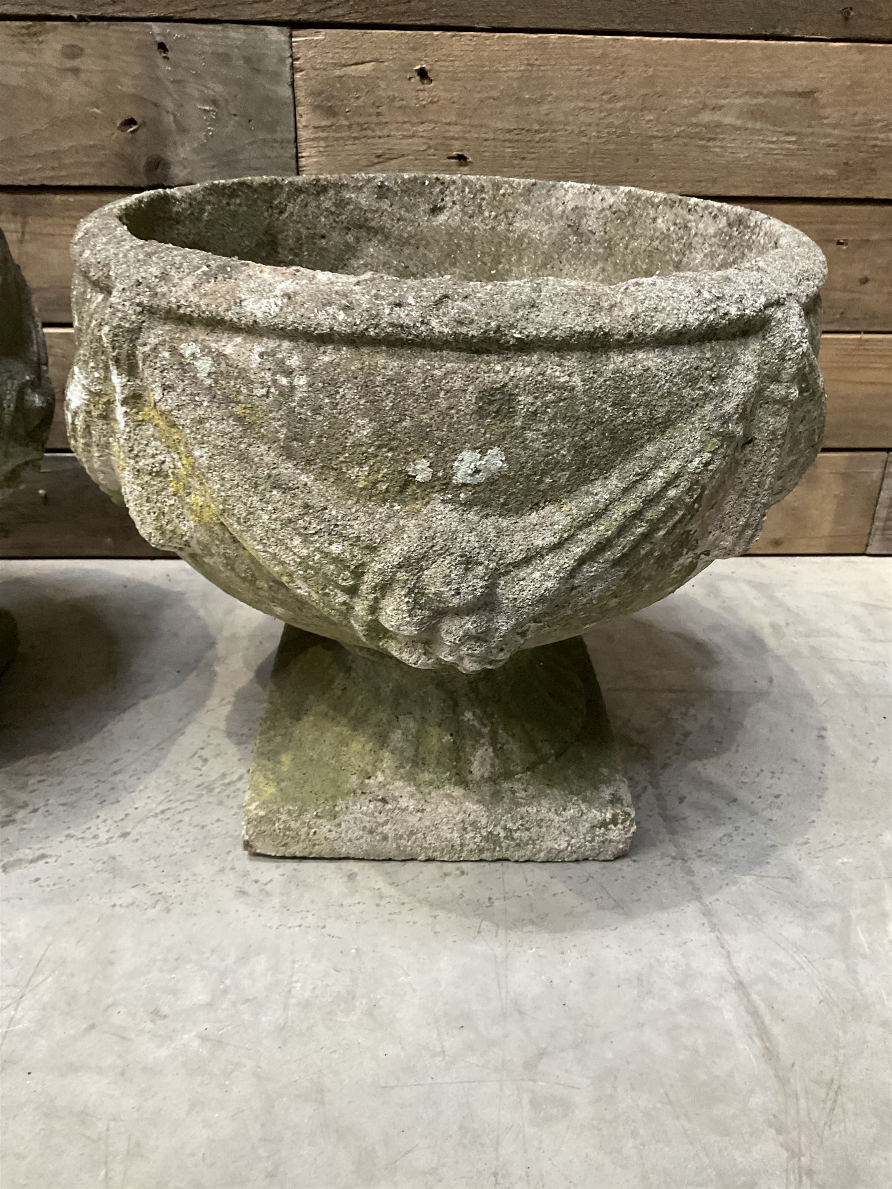 Pair of circular cast stone circular planters, and a similar pair decorated with swags (4)