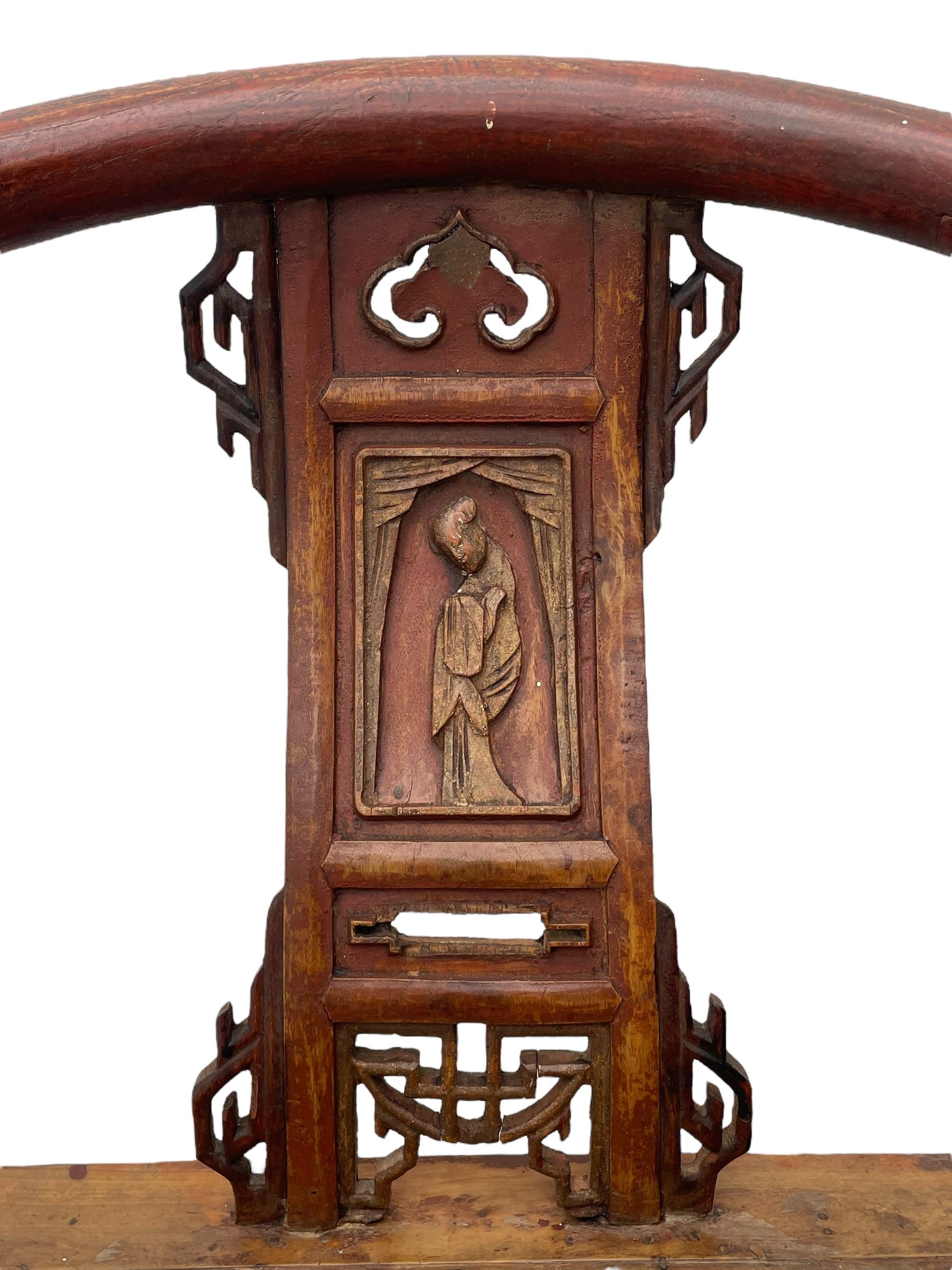 Late 19th century Chinese Qing dynasty horse shoe armchair, in elm, hung mu and Chinese softwood, horse shoe shaped upper rail carved with scroll terminals, shape back carved with solitary figure in robes, rectangular panelled seat in moulded frame, decorated with fretwork panels, on square supports united by stretchers 