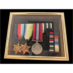 World War II medal group, including Atlantic Star and General Service medal, inscribed Thomas Crawford in glazed display frame