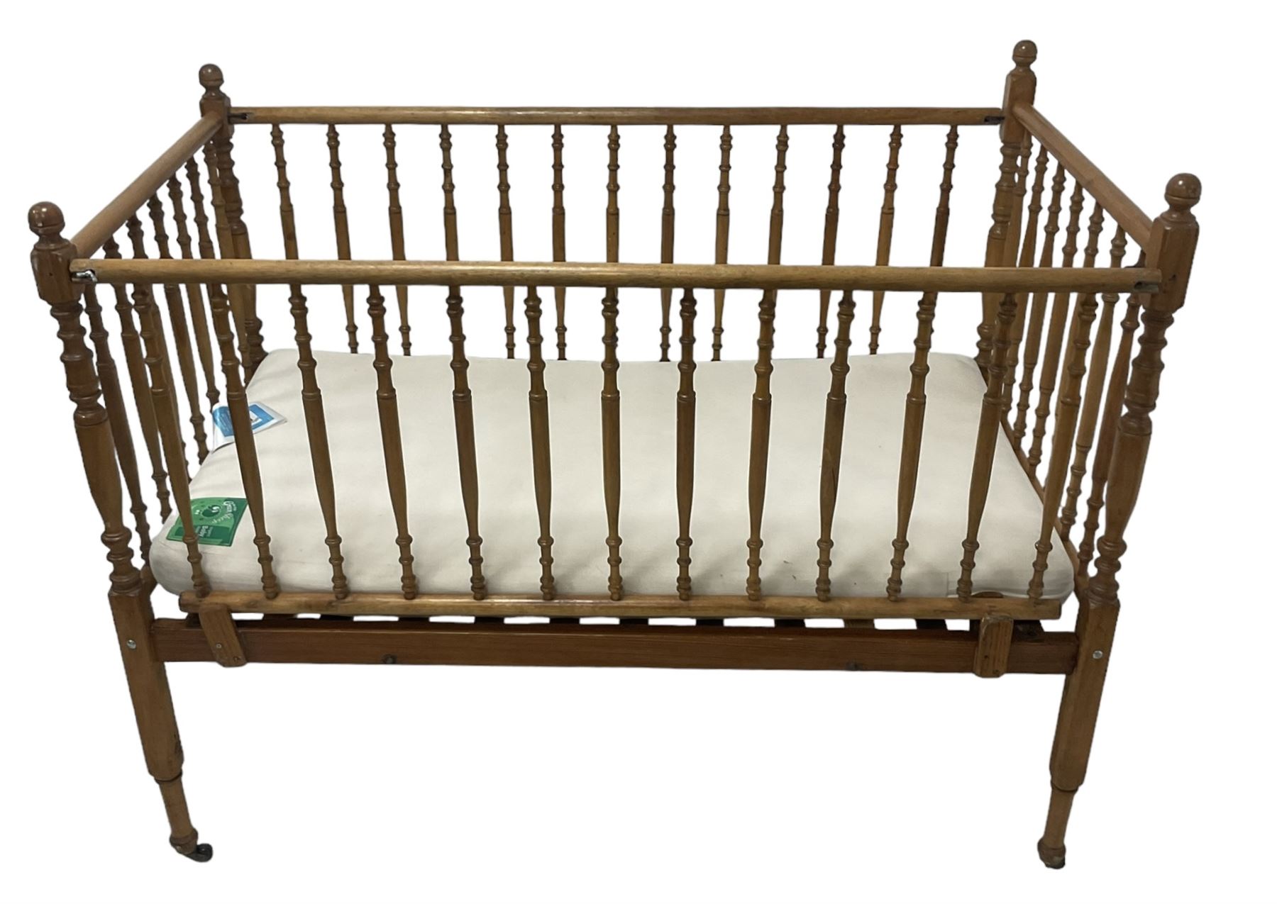 Victorian beech and pitch pine crib, turned spindle gallery supports, raised on square tapering supports with castors