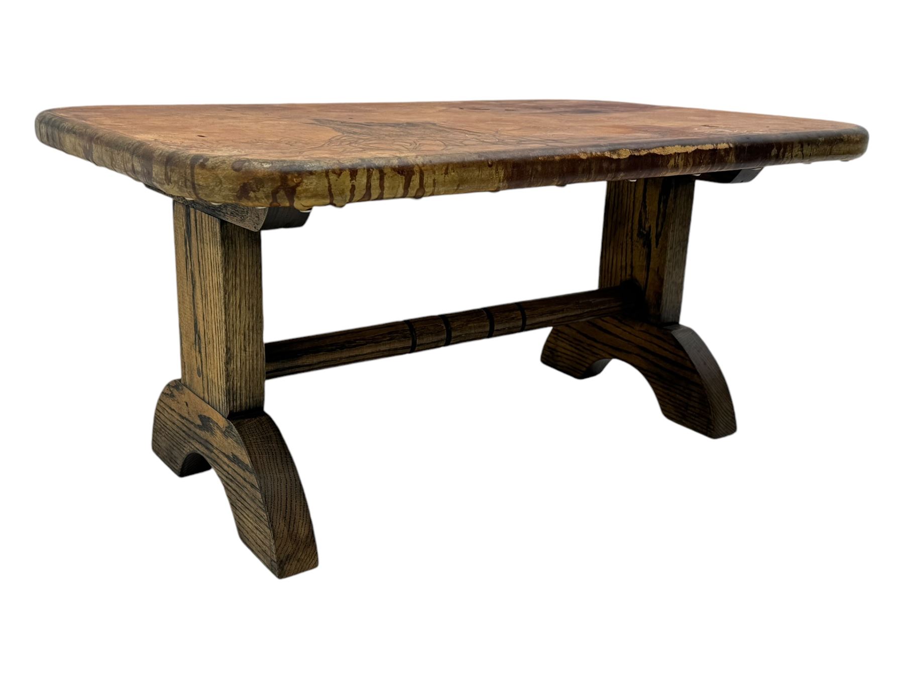 Rectangular oak coffee table, rectangular top with tan leather cover decorated with naturalistic scene, on rectangular end supports and curved feet united by turned stretcher 