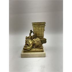 Gilt metal spill vase, the vase modelled as a a barrel with putti amongst fruiting vines laid before, upon rectangular base and rectangular marble plinth, H13.5cm