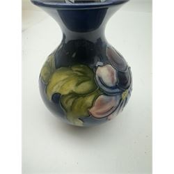 Moorcroft vase in Clematis pattern, together with small vase in Bermuda Lily pattern, Hibiscus pattern trinket box and Magnolia pattern trinket dish, all with makers mark beneath, vase H13cm