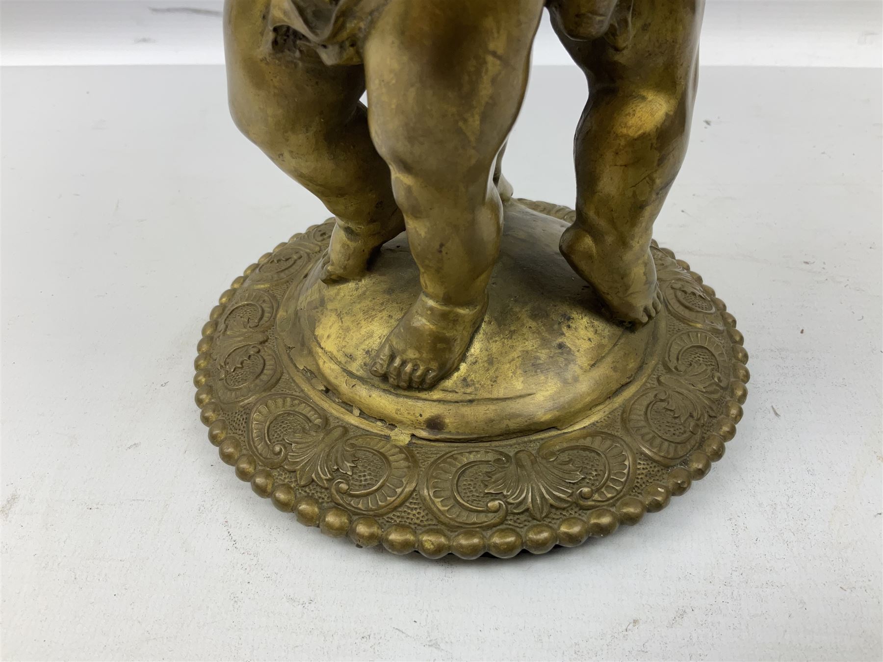 Brass centrepiece modelled as two cherubs supporting a marble bowl, stood upon a foliate design base, H32cm