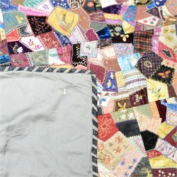 Victorian crazy pattern patchwork quilt, of irregular scraps, within a silk and lace borde...