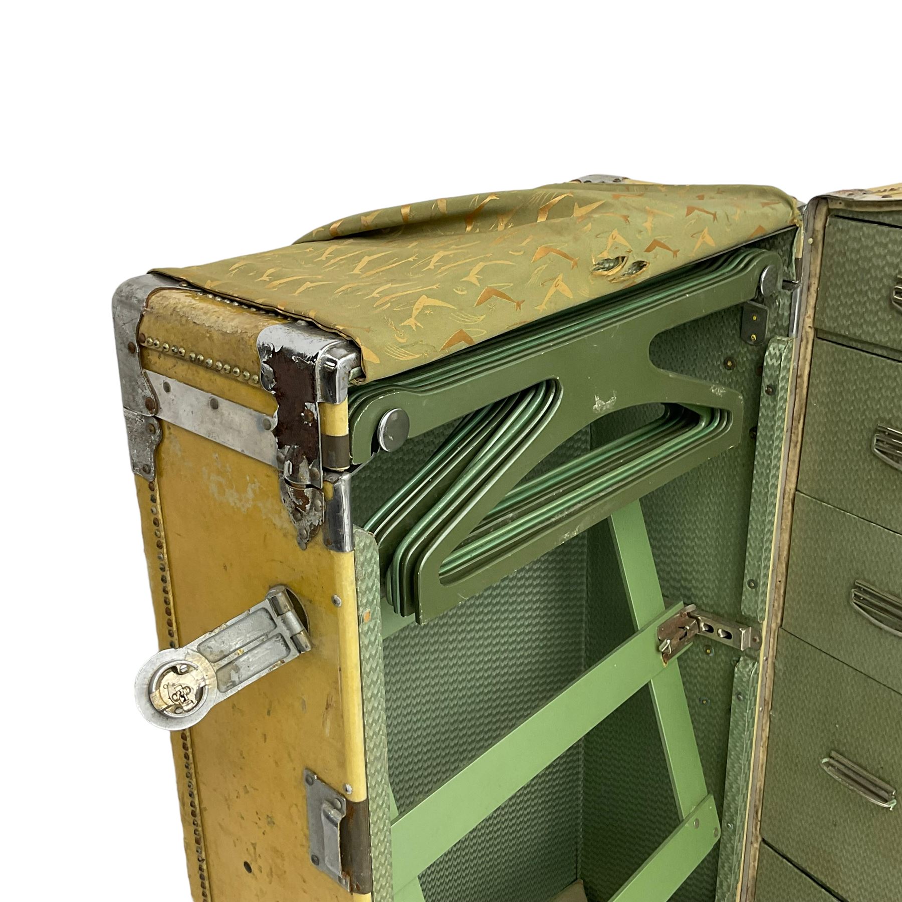 Early 20th century steamer traveling trunk, in yellow finish with chrome fixtures, the interior fitted with drawers and hangers, with various travel labels 