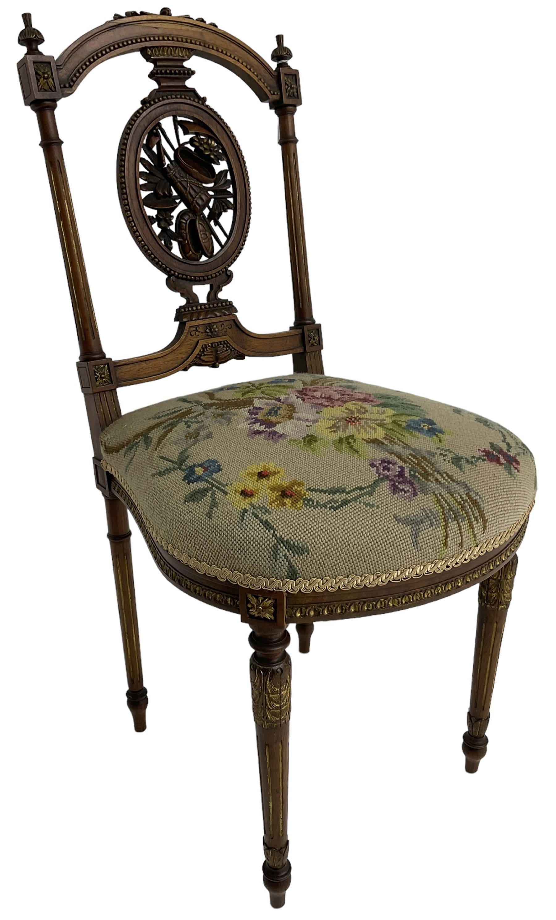 Late Victorian walnut side chair, arched cresting rail over carved and pierced splat depicting baskets and foliage, floral needle work upholstered seat, on acanthus carved and fluted turned supports