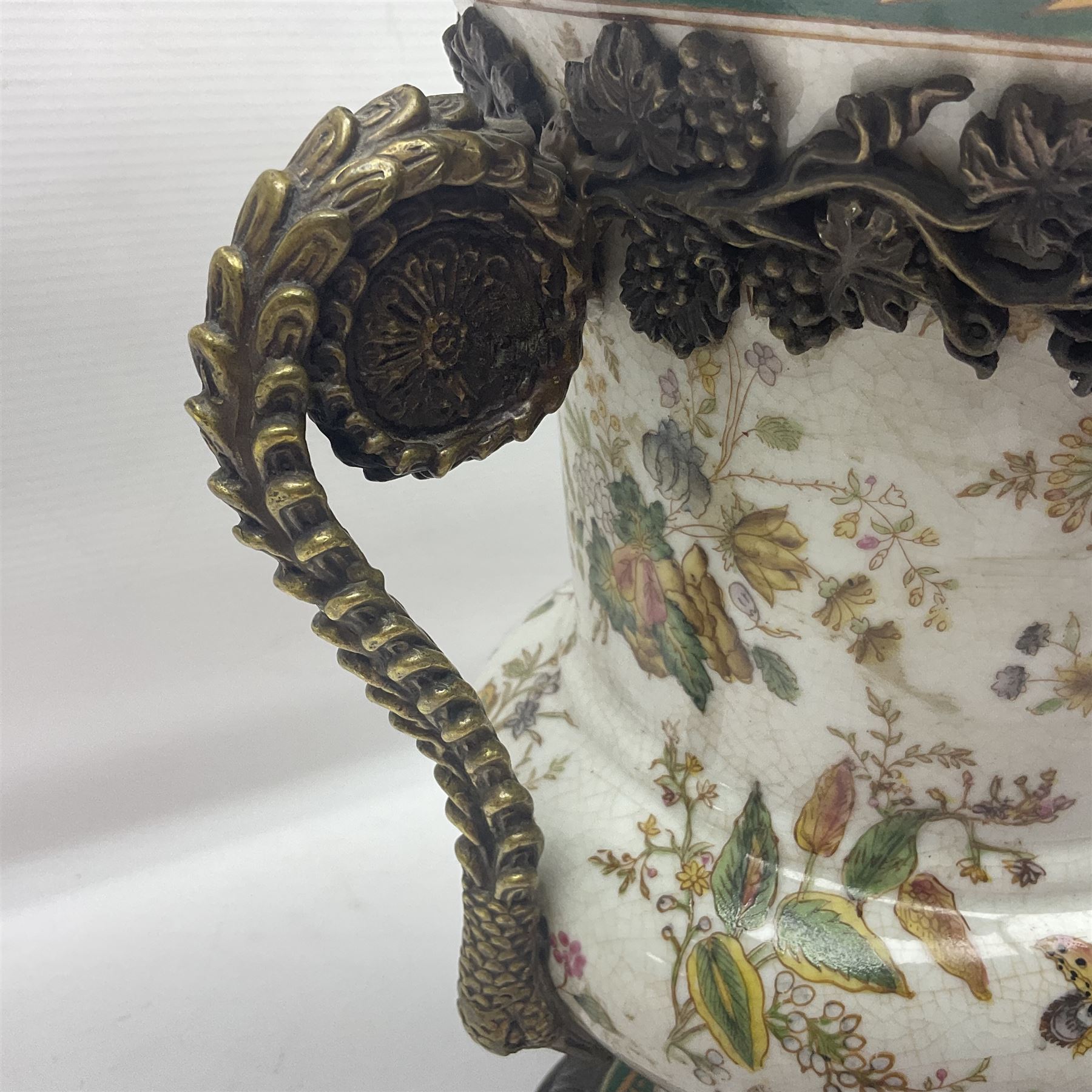 Wong Lee, twin handled ceramic urn with enamelled floral decoration and bronzed metal mounts, marked to base, height 33cm