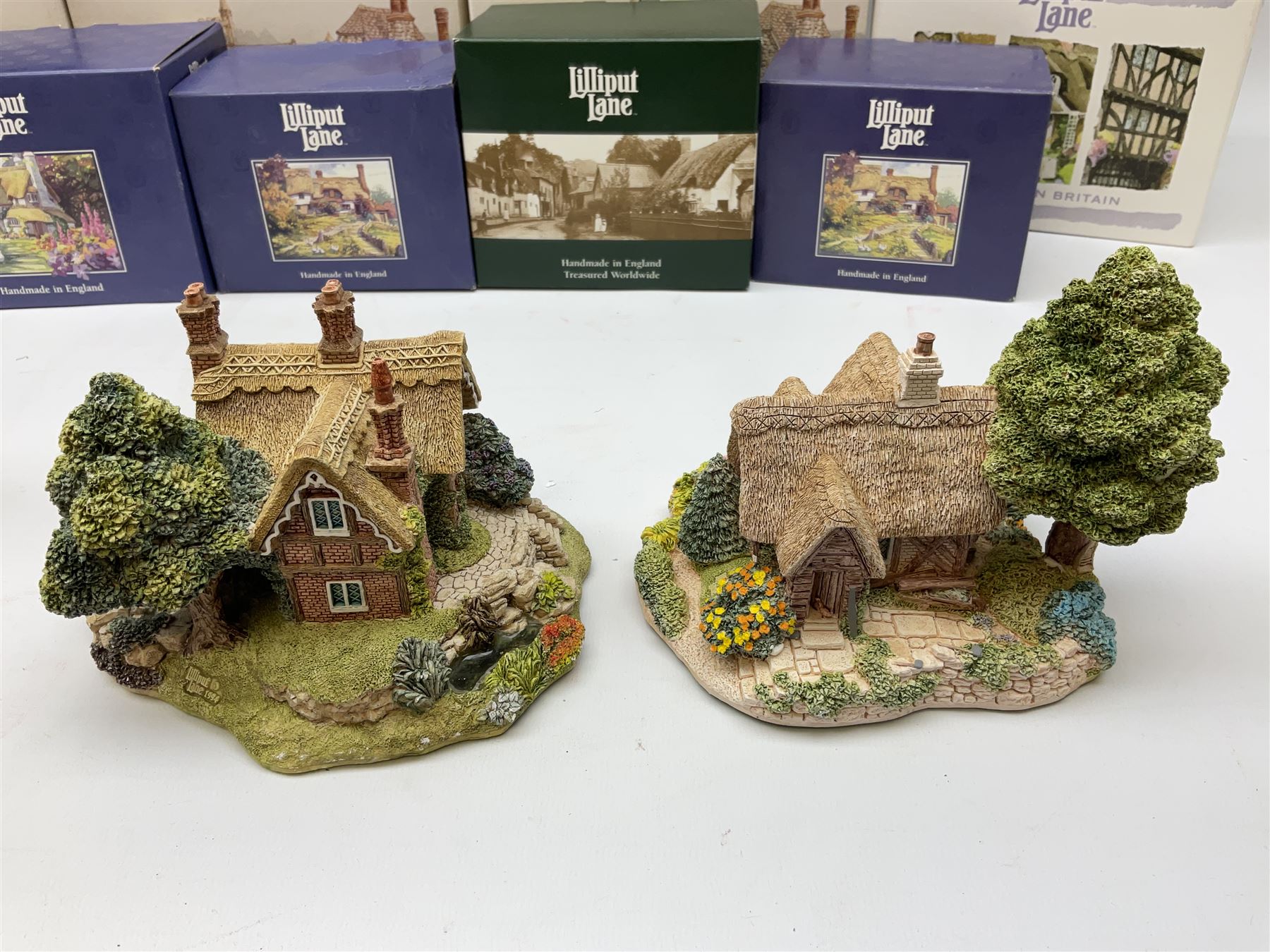 Twelve Lilliput Lane models to include The 1994 Anniversary Cottage Watermeadows, Collector's Club Woodman's Treat, Castle Hill, Huddersfield, Symbol of Membership Kiln Cottage etc, all boxed, eight with deeds