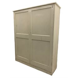 Large Victorian white painted pine cupboard, enclosed by two panelled doors 