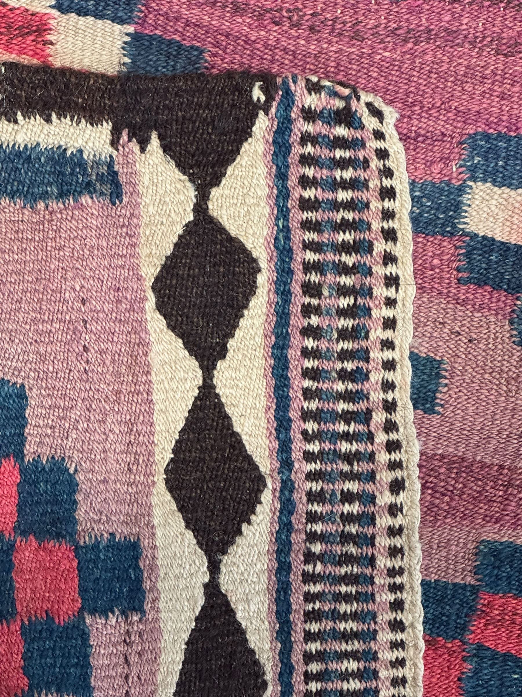 Turkish Anatolian lilac ground kilim rug, the field decorated with three columns of geometric lozenges, enclosed by plain guard stripes 