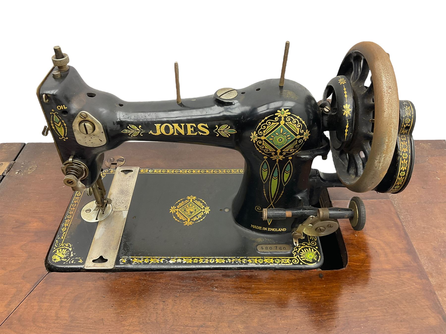 Early 20th century Jones treadle sewing machine table, bevel edged rectangular top with hinged lid enclosing sewing machine no. 480760, supported by cast iron treadle base