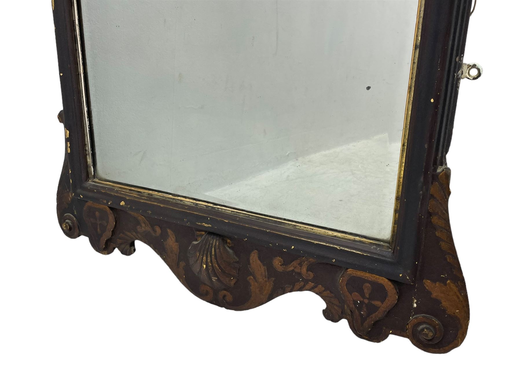 18th century black lacquered and gilt wall mirror, broken arch pediment with central cartouche decorated with curled leaves and foliate motifs, scrolled acanthus leaf eared brackets, bevelled mirror plate within gilt slip and moulded outer frame, lower shell motif surrounded by curled acanthus leaves and shield motifs 